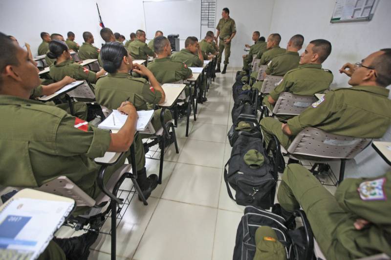 “A sociedade está prestes a receber novos policiais, profissionais prontos e treinados para defender o cidadão. Mesmo ainda não tendo encerrado o curso, já me sinto um PM. A instituição pode ter certeza que estarei sempre de pronto-emprego para atender no que ela precisar de mim”. A fala do aluno do Centro de Formação, dita nesta segunda-feira (7) durante uma aula do Curso de Formação e Aperfeiçoamento de Praças (CFAP) da Polícia Militar do Pará, demonstra o sentimento dos cerca de 2 mil homens e mulheres que estão próximos de encerrar o curso e iniciar seus trabalhos nas ruas. Em Belém, na sede do CFAP, estão em fase de conclusão da formação, cerca de 500 alunos (foto), entre homens e mulheres. Já no interior do Estado, outros 1. 500 passam pelo curso que também acontece nos municípios Conceição do Araguaia, Itaituba, Santarém, Marabá, Parauapebas, Castanhal, Santa Izabel do Pará, Tucuruí, Paragominas, Capanema, Bragança, Altamira, Barcarena, Soure e Breves. A previsão é que no início de agosto deste ano, todos já estejam efetivamente nas ruas. Aprovados no último concurso público da instituição, os futuros policiais estão desde outubro de 2017 participando de um novo modelo formação. De acordo com o major Arthur Silva, sub-comandante do CFAP, a mudança na grade do curso quase dobrou o número de horas aula.
FOTO: RODOLFO OLIVEIRA / AG. PARÁ
DATA: 08.05.2018
BELÉM - PARÁ <div class='credito_fotos'>Foto: Rodolfo Oliveira/Ag. Pará | <a href='/midias/2018/originais/7b2d459f-3387-4a64-88d8-b74d11fabc7f.jpg' download><i class='fa-solid fa-download'></i> Download</a></div>