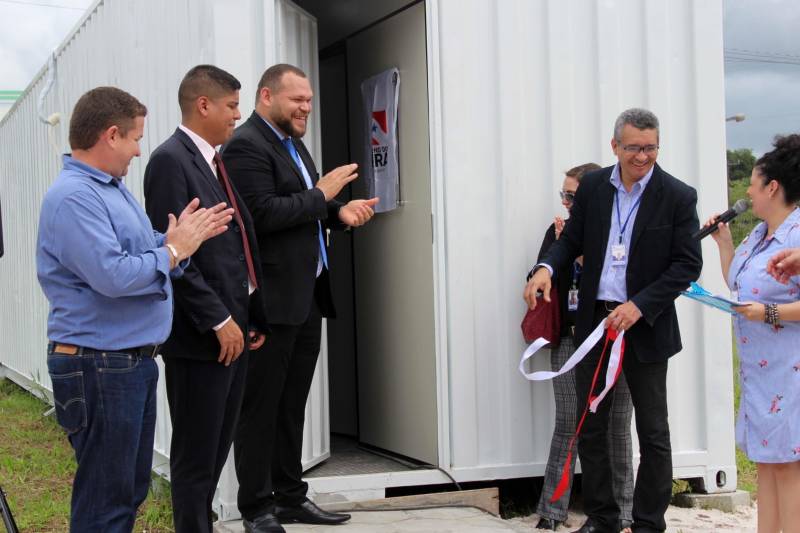 A Superintendência do Sistema Penitenciário do Estado (Susipe) inaugurou, nesta terça-feira (18), no Complexo Penitenciário de Santa Izabel, um espaço com seis salas de vídeo audiência (foto) que vão funcionar dentro de um contêiner de 30 m², totalmente reformado e adaptado. Cada sala está equipada com central de ar condicionado, televisão conectada ao equipamento de videoconferência (câmera e microfone), duas cadeiras e câmera de segurança. Todas as salas estão conectadas diretamente com o Tribunal de Justiça do Pará via cabos de fibra óptica, com um link dedicado com velocidade de 100 megas. O investimento foi de mais de R$ 1 milhão de reais, dos recursos do Fundo Penitenciário Nacional. Em 2018, a Susipe recebeu 12.300 pedidos de audiências, só que 12% não foram atendidos, principalmente por dificuldades de logística e escolta. Para o superintendente da Susipe, Michell Durans, o novo espaço terá um impacto muito grande na redução de custos com transporte e agilidade das audiências.

FOTO: VELOSO JÚNIOR / ASCOM SUSIPE
DATA: 18.12.2018
SANTA IZABEL - PARÁ <div class='credito_fotos'>Foto: Veloso Junior / Ascom Susipe   |   <a href='/midias/2018/originais/9e95c591-f55c-48c1-9aa1-124d499c8920.jpg' download><i class='fa-solid fa-download'></i> Download</a></div>