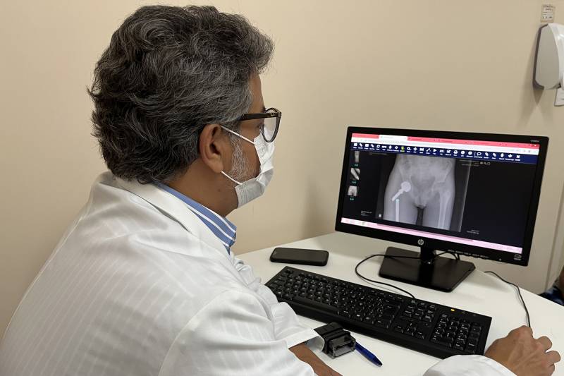 O oncologista ortopédico Fernando Brasil, do Hoiol, avalia exames de imagens do paciente.