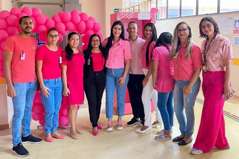 Colaboradores e colaboradoras com vestimenta em tom de rosa para celebrar outubro